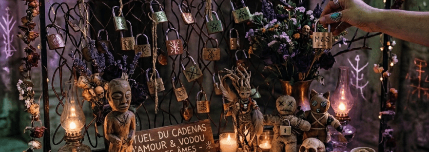 Table with love locks, candles, flowers, and a sign for love lock ritual